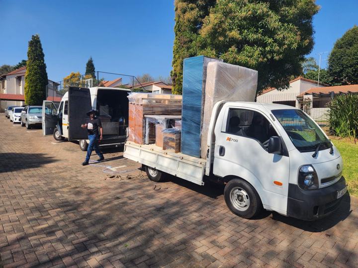 Kia bakkie loaded with a wrapped wardrobe and furniture